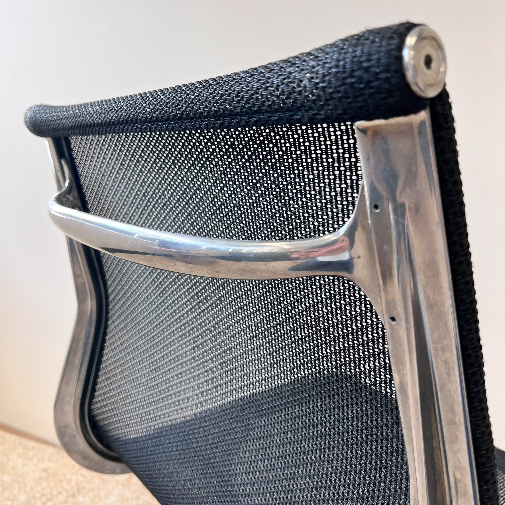 Seat back detail of Eames Aluminium Group Executive Chair by Herman Miller in Black Mesh seat and back